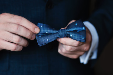man holding a bow tie