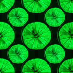 Fototapeta na wymiar seamless pattern of slices of green citrus fruit with backlight isolated on black background, can be tiled