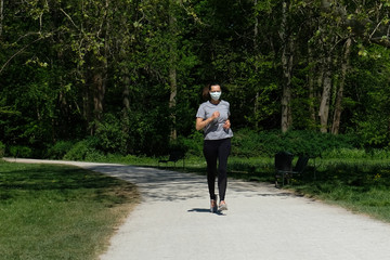 Woman running during coronavirus pandemic with face mask