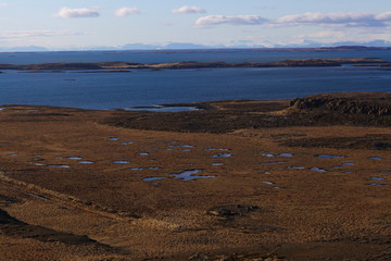 Emotional old-fashioned portrait of a girl in retro style in a light transparent dress with shiny elements on the shoulders.