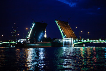 Fototapeta na wymiar Raising bridge over the Neva river in Saint Petersburg. Night landscape. The lights of the night city are reflected in the water