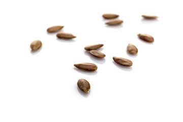 Healthy grains organic Brown Flax seeds background. Pile nutrition Linseed isolated on white. Dieting and detoxication concept with mineral nutrients. Macro close-up shot.