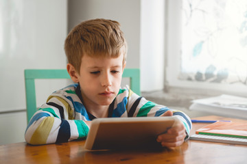 Young Boy Looking at Digital Tablet	
