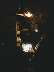 A light bulb lighting a portion of a dental clinic after a hectic duty in a time of pandemic.