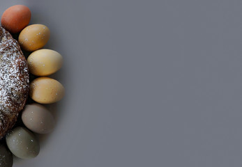 Easter colored eggs are laid out in a semicircle adjacent to the cake on the edge of the frame....