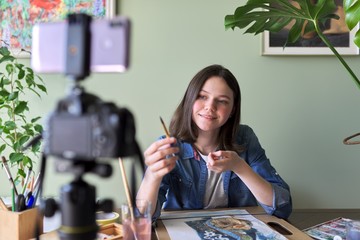 Artist girl painting with watercolors and making videos for her channel blog