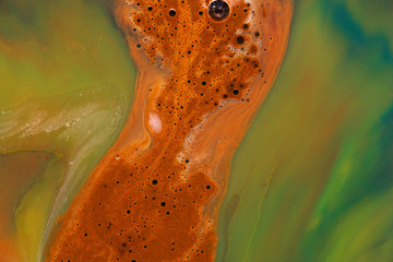 Brown liquid from mixed colors. Waves and patterns of bright colors, reminiscent of the figure of a...