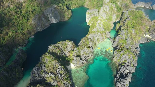 View from above, stunning aerial view of the Big Lagoon and the Small Lagoon, two beautiful bays of crystal clear water surrounded by rocky cliffs. Bacuit Bay, El Nido, Palawan, Philippines.