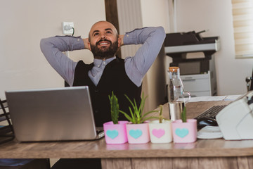 daydreaming young man resting happily in office