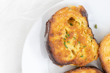 Top view of French toast served on the white plate with white background