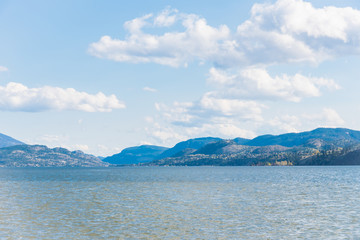 Scenic Skaha Lake, distant mountains, and blue sky with clouds