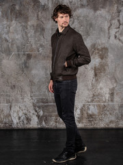 Obraz premium Full length studio portrait of attractive young man. Young Male Fashion Model Posing In Casual Outfit. 