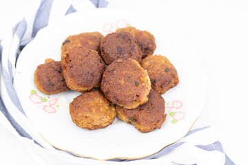 Fried meatballs served on the plate with white background