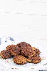 Fried meatballs served on the plate with white background