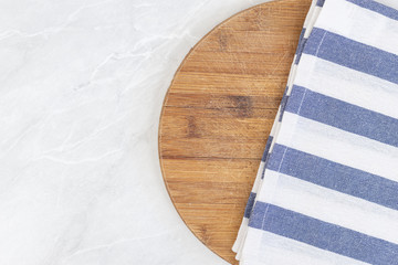 Flatlay above kitchen wooden board with kitchen dishtowel with copy space
