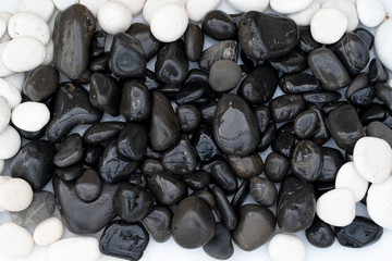 Fototapeta na wymiar stones of black and white pebbles with water drops. abstract background, spa
