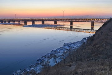 Ice floating on the Amur river. Motion blur. Amur bridge area. Trans siberian railway. Khabarovsk, far East, Russia.