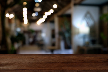 wood table on blur of cafe, coffee shop, bar, resturant, background - can used for display or montage your products