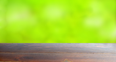 Empty wood table top on blur abstract green from garden in morni