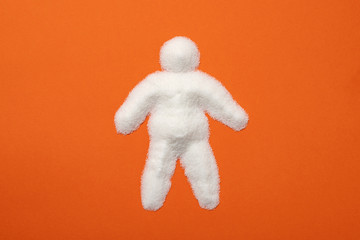 Obese man silhouette made with lots of refined white powdered sugar. Visual metaphor indicating the harmful effects of sugar on the human body.