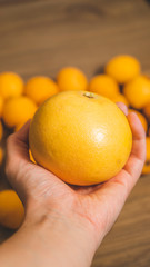 Big grapefruit with medlars at background