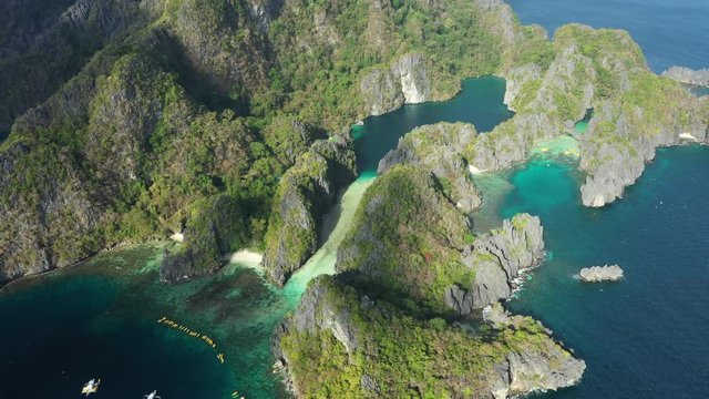 View from above, stunning aerial view of the Big Lagoon and the Small Lagoon, two beautiful bays of crystal clear water surrounded by rocky cliffs. Bacuit Bay, El Nido, Palawan, Philippines.