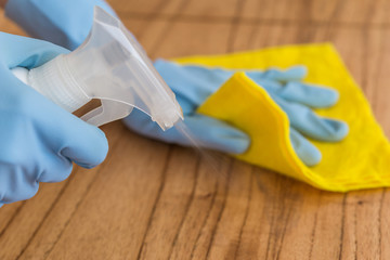 Disinfecting a table surface at home with rubbing alcohol for prevention of coronavirus covid-19...