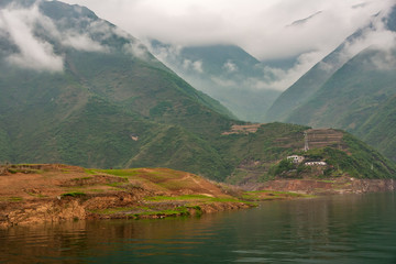 Wuchan, China - May 7, 2010: Dragon Gate Gorge on Daning River. Landscape with multiple tall green...
