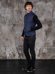 Full length studio portrait of attractive young man. Young Male Fashion Model Posing In Casual Outfit. 