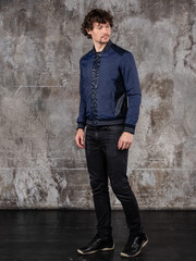 Full length studio portrait of attractive young man. Young Male Fashion Model Posing In Casual Outfit. 