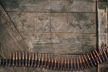 Machine gun belt with cartridges for MG 34-42 of the USSR on a wooden background