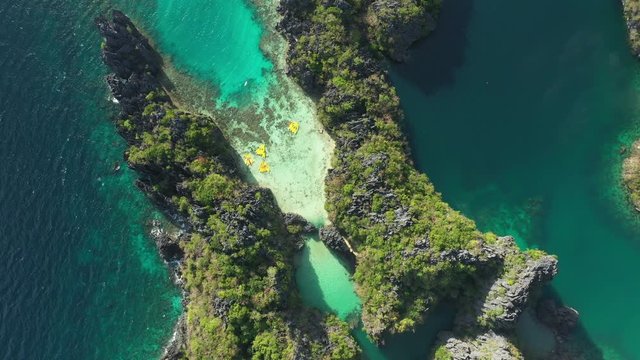 View from above, stunning aerial view of the Big Lagoon and the Small Lagoon, two beautiful bays of crystal clear water surrounded by rocky cliffs. Bacuit Bay, El Nido, Palawan, Philippines.