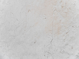 Beige stucco wall crackle surface. Light beige textured background. Grunge texture.