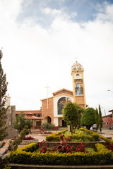 Fototapeta na wymiar the clock tower of the cathedral of a city in Ecuador - El Pan