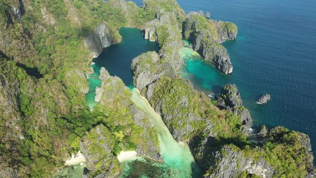 View from above, stunning aerial view of the Big Lagoon and the Small Lagoon, two beautiful bays of crystal clear water surrounded by rocky cliffs. Bacuit Bay, El Nido, Palawan, Philippines.