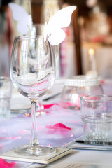 Wedding table setup with wine glasses and petals