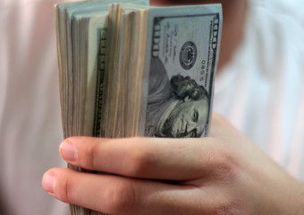 Stack of one hundred dollar bills close-up.
American dollars in one hundred banknotes.