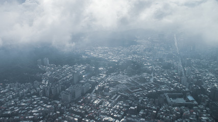 Obraz premium The view across Taipei, captial of Taiwan, from the top of Taipei 101, the second largest building in the world,shoot after raining with fog.