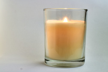 candle in glass jar with white background