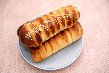 long bun with sesame seeds on a plate