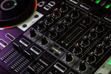 Fototapeta na wymiar Mixer section of Pioneer DJ Controller in music store shiny new knobs