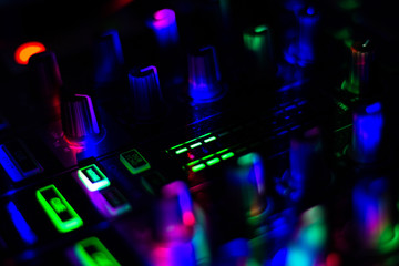Close up of Volume level indicator of DJ mixer in club night party bright colorful buttons