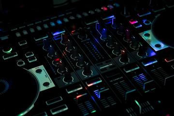 Fototapeta na wymiar Blue light spots on DJ Controller in Club night all in one controller