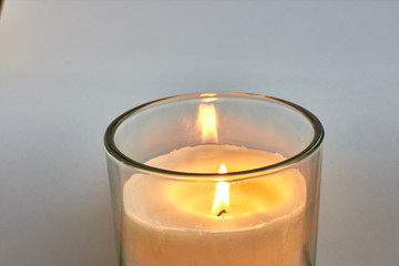 candle in glass jar with white background