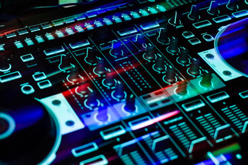Streaking Lights across portable DJ controller during night club party