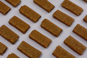 Milk Chocolate wafer stick cookies in rows on lavender purple background