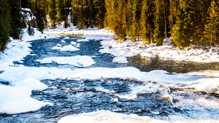 The partly frozen Murtle River right after Dawson Falls in the Cariboo Mountains of Wells Gray...