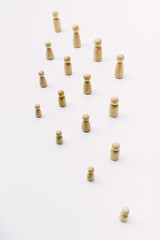 Social distance symbolized with wooden figures isolated from each other on white background.