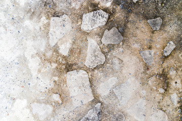 cement floor with stones. light gray with black parts