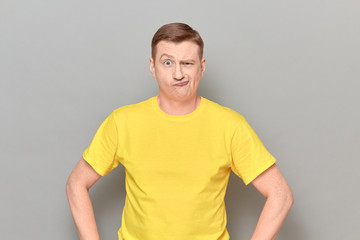 Portrait of funny blond mature man with goofy perplexed expression